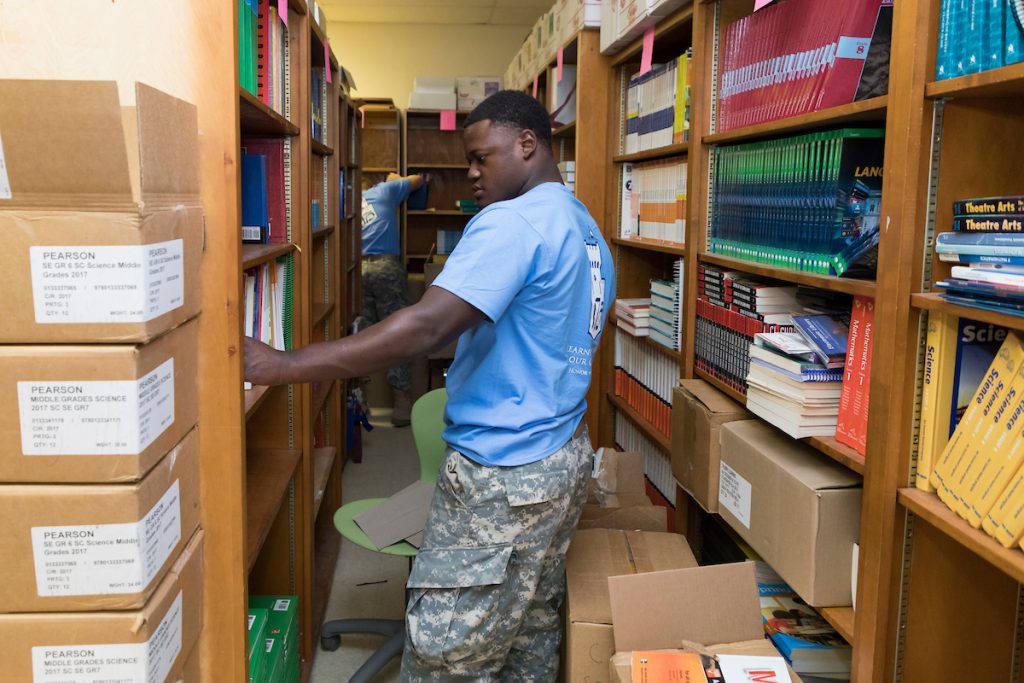 Cadet puts books away