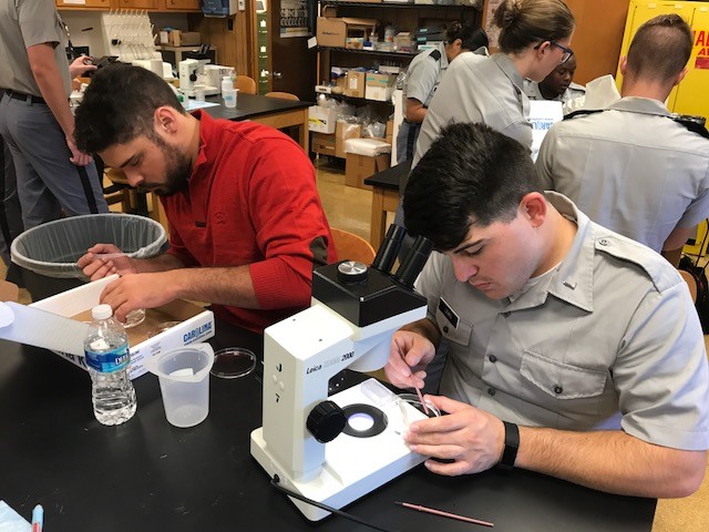 Adam DeGenova and Cadet Kyle Lewis researching their hypotheses