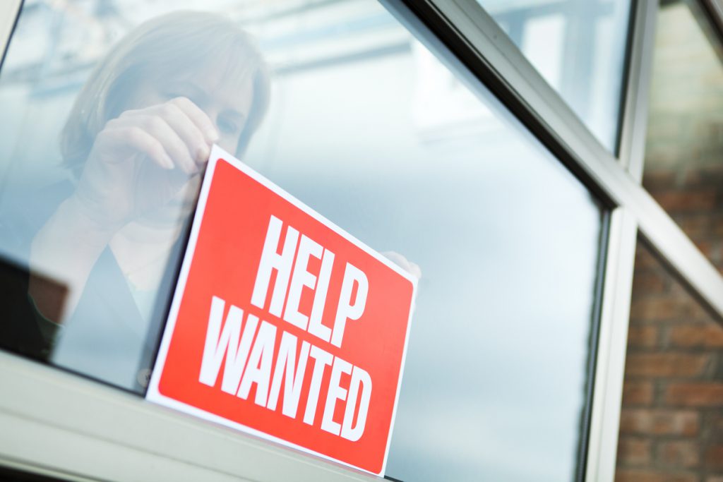 business using help wanted sign to fill job openings in the Southeast