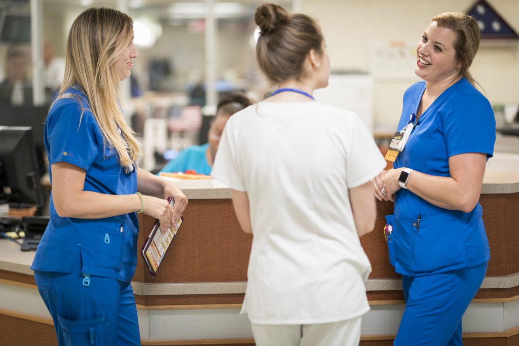 Banks and Doney speak with another nursing student at the VA