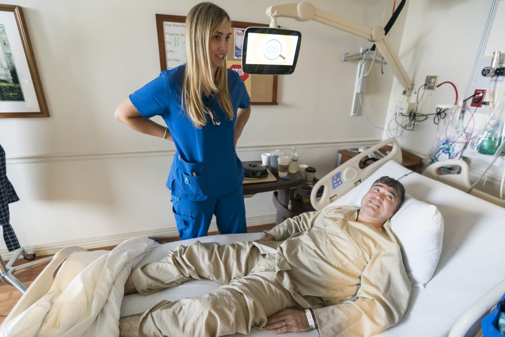 Citadel nursing student Emily Banks visits with VA patient Jose Atkinson