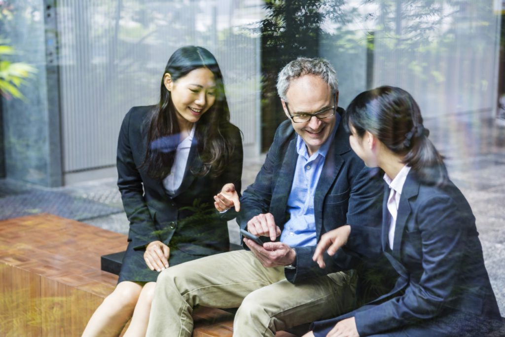 businessman working with Japanese business women on an important project