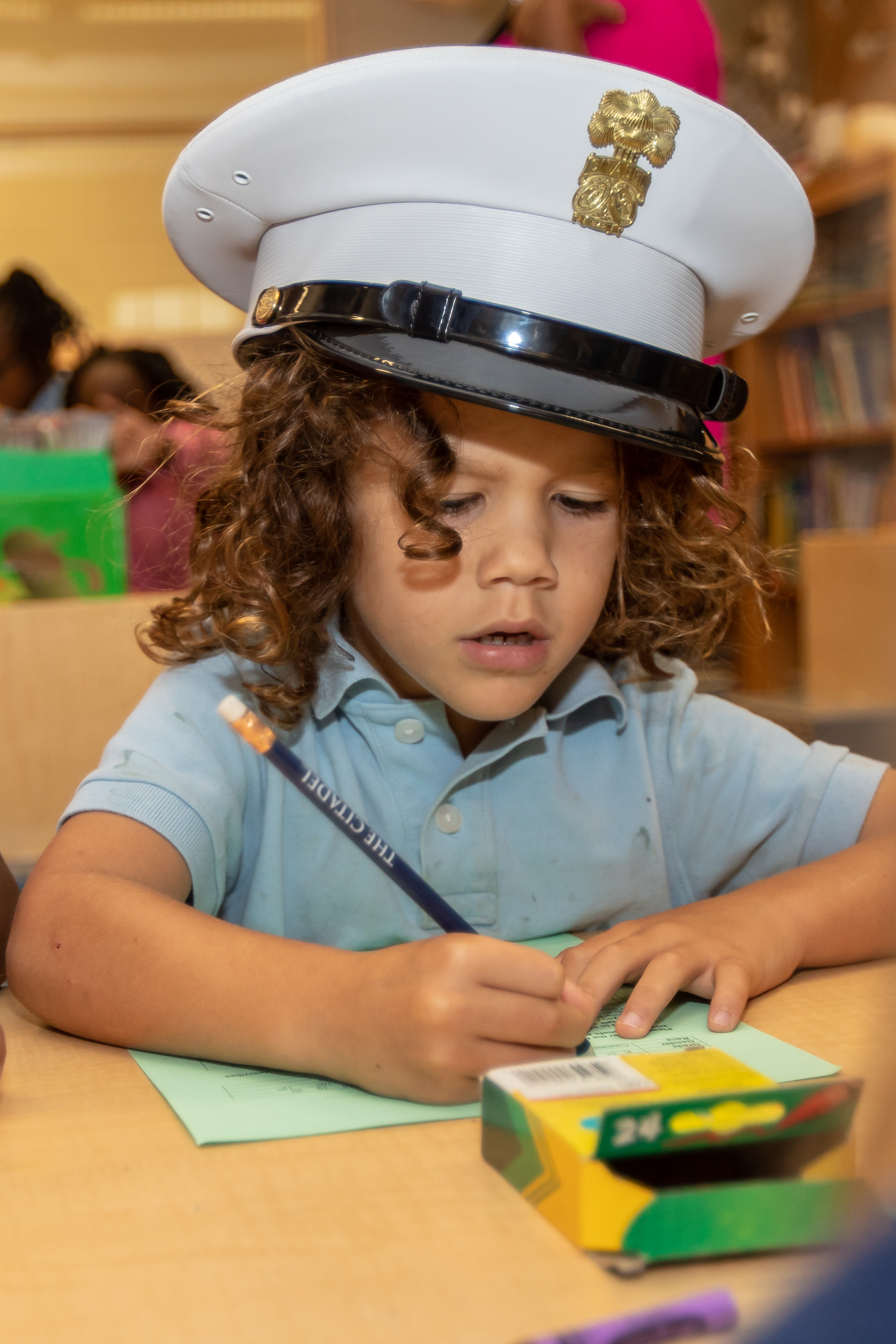 James Simons elementary student enjoys pretending to be a cadet while making a card for her hero