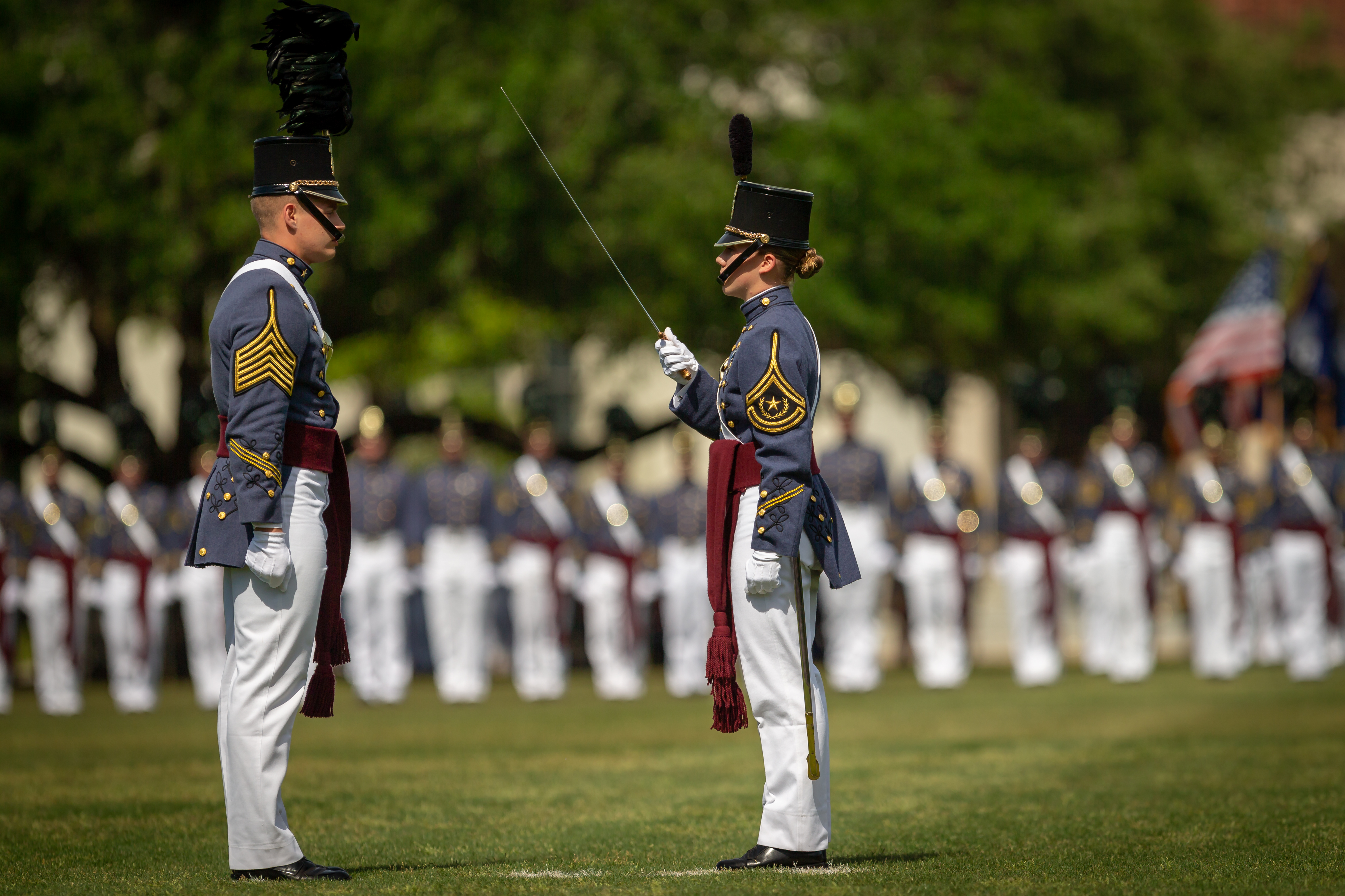 Sarah Zorn accepts the Regimental Commander's sword from Dillon Graham during the change of command ceremony in May of 2018