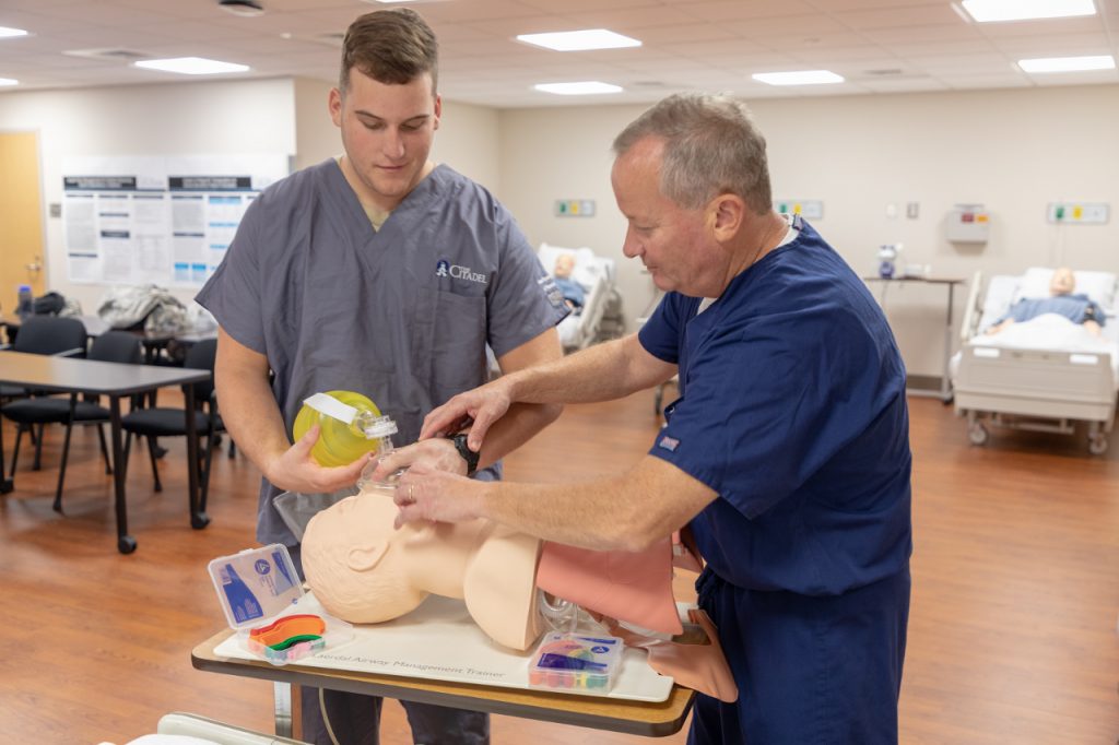 Citadel football player and nursing student Blake Oliveira (left) works with Dr. James Pelletier in the nursing lab