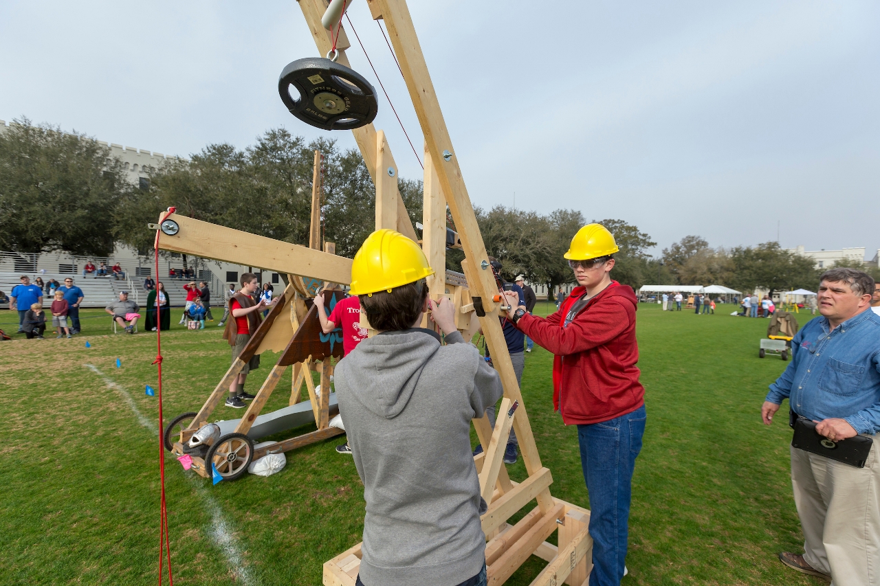 Jamison Mahoney, 17 in grey, and Byron DeJesus, 17, both of Chapin, SC., and the Center for Advanced Field Studies, prepare their trebuchet for competition at Storm the Citadel 2018