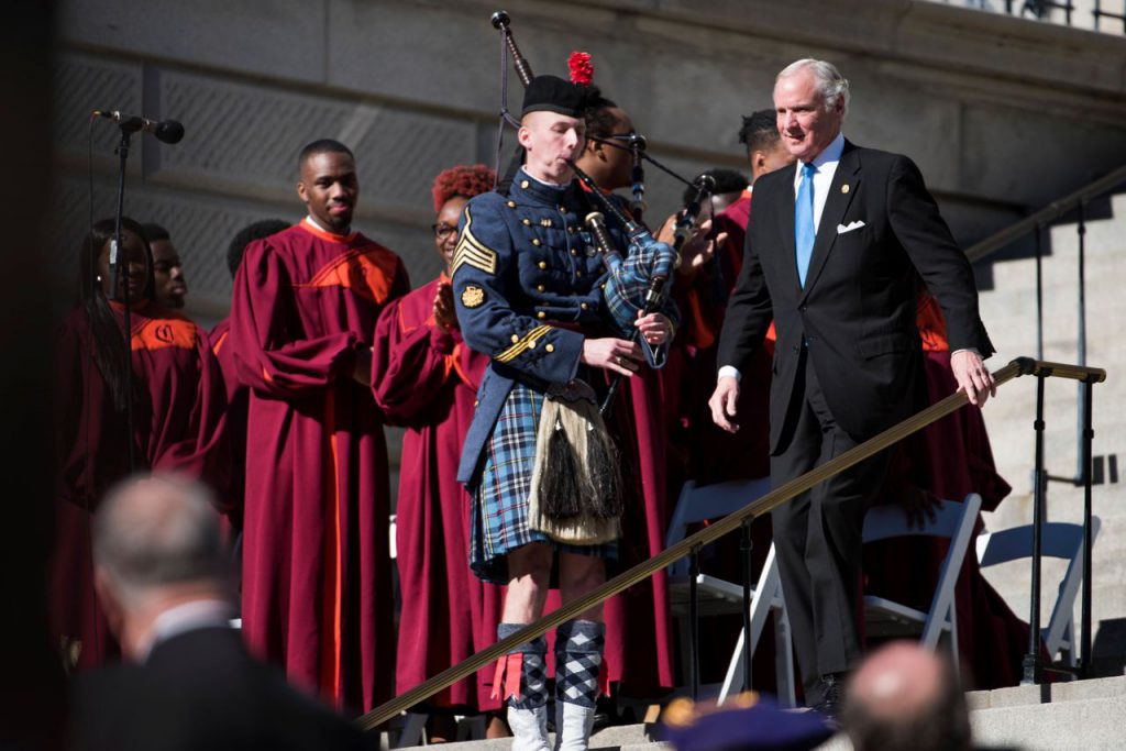 Citadel Cadet Richard Johnson playing bagpipes at inauguration as Gov. McMaster descends stairs