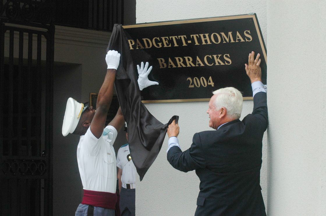 Fritz Hollings with cadet during dedication of new Padgett-Thomas Barracks, 2004, laughing as sign falls during unveiling