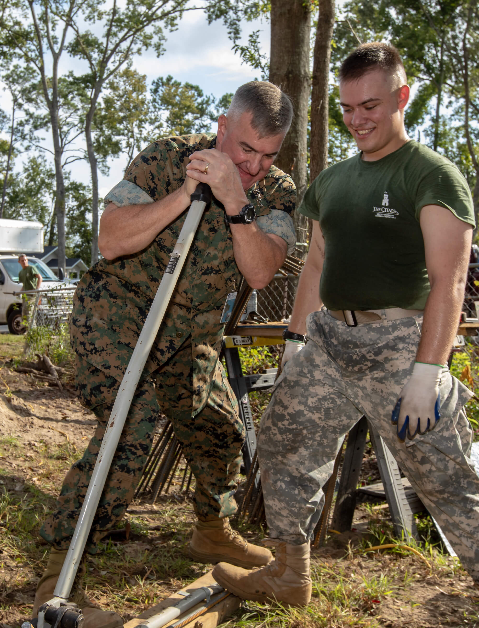 General Glenn Walters, president of The Citadel, helps a cadet bend a piece of rebar on Leadership Day 2018.