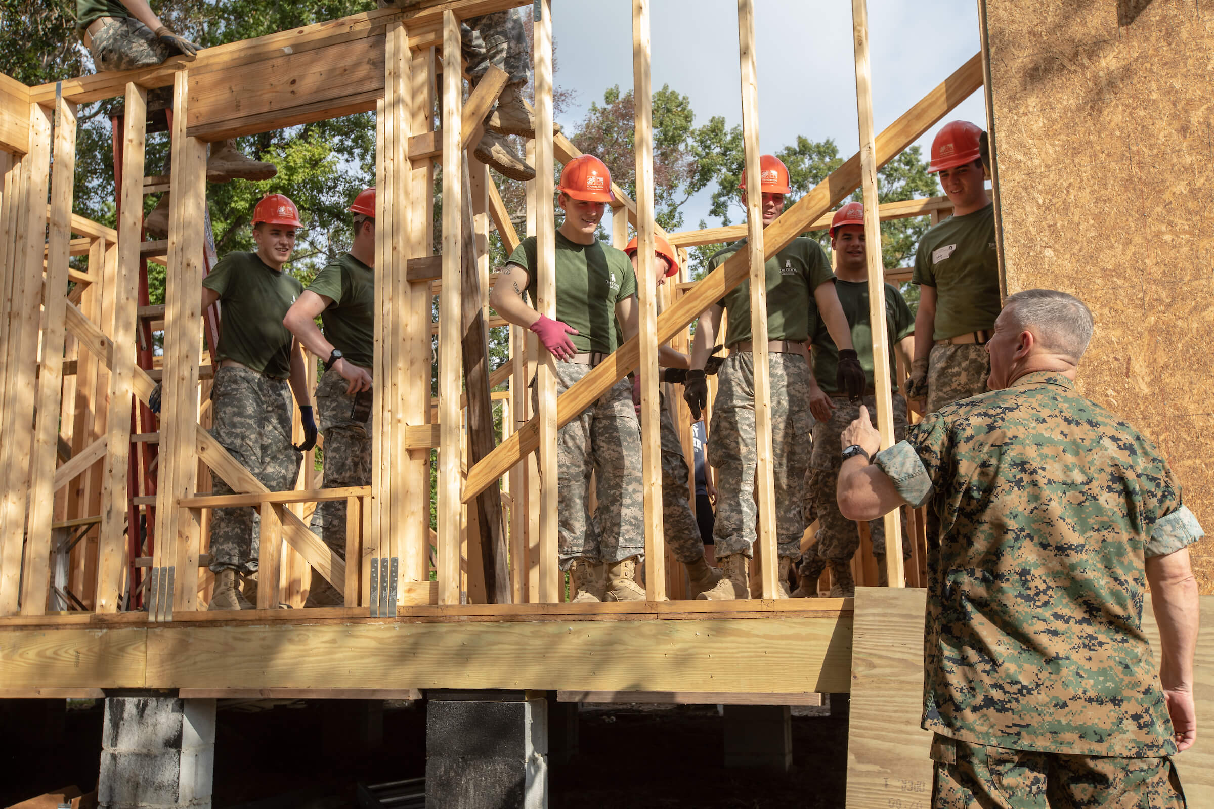 General Glenn Walters, president of The Citadel, speaks with cadets on the job site at Sea Island Habitat for Humanity on Leadership Day 2018.