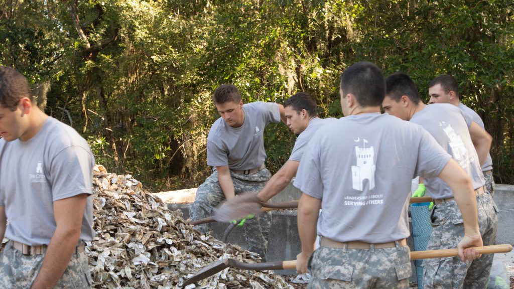 Cadets shoveling oyster shells at U.S. Fish and Wildlife