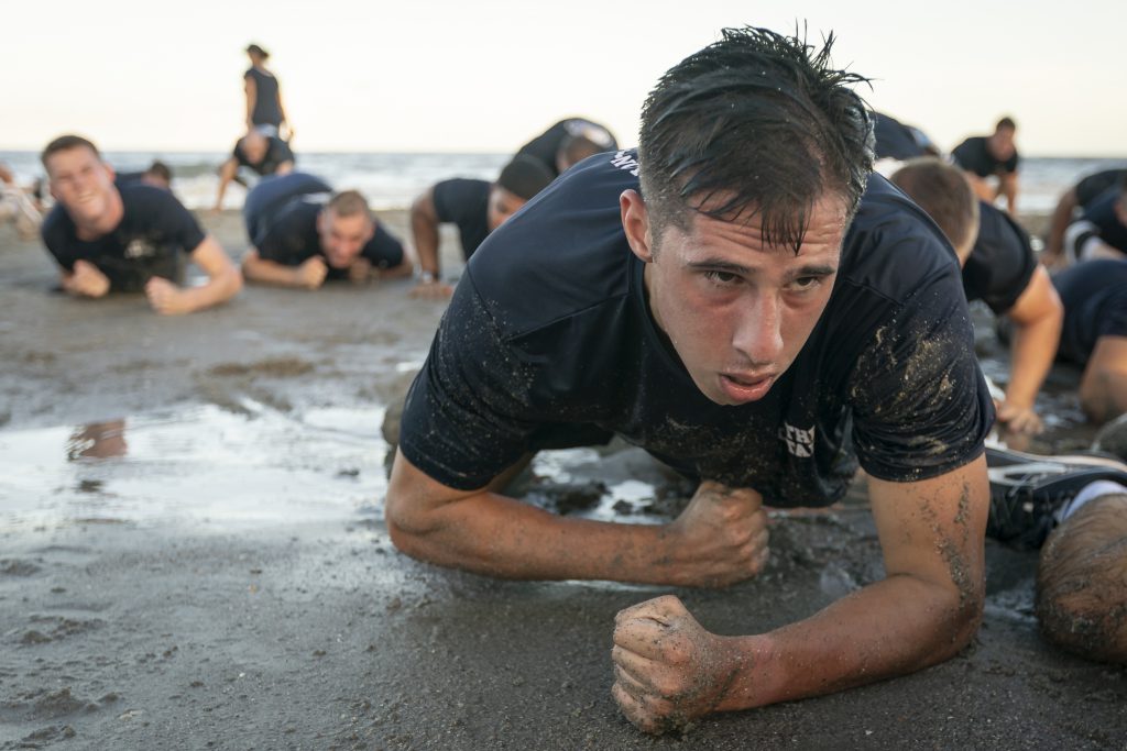 Cadets crawling on the beach in training excercise