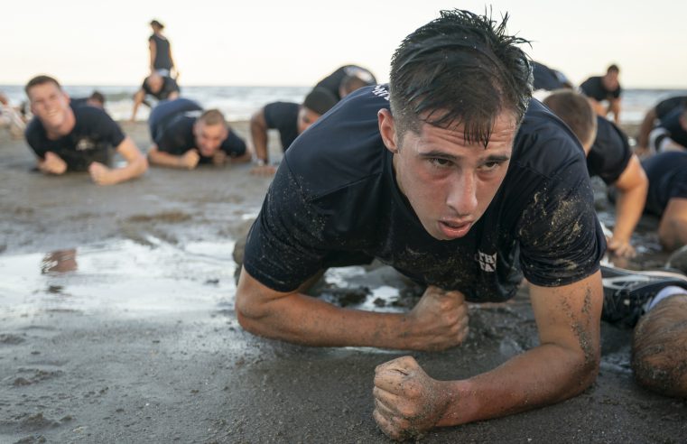 Cadets crawling on the beach in training excercise
