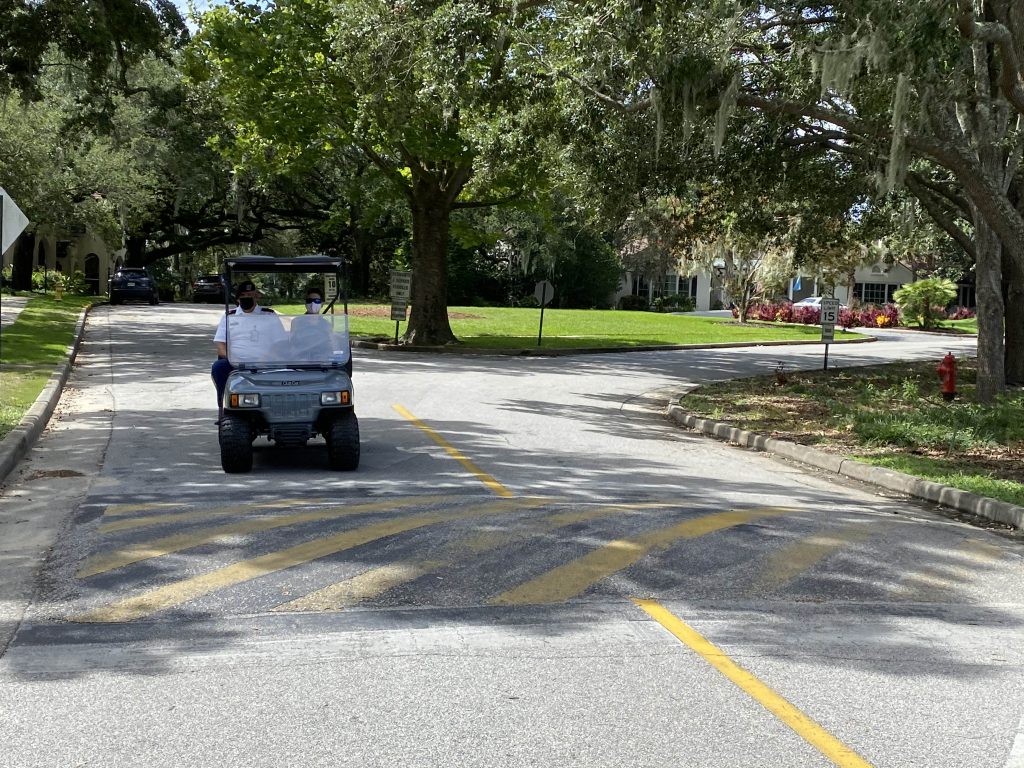 Cadet activities team in a golf cart delivering meals on campus.