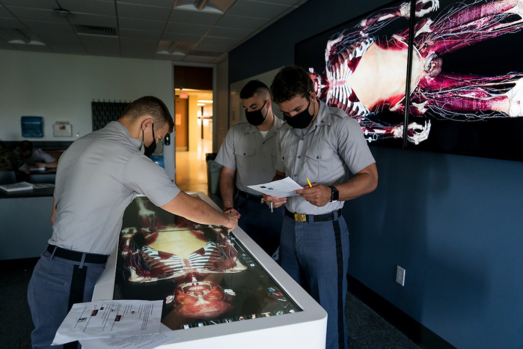 Cadets work with Dr. Clinton Moran, Biology, on a new Anatomage table, the newest addition to Duckett Hall’s state-of-the-art anatomy and physiology lab at The Citadel in Charleston, South Carolina on Tuesday, August 31, 2021. Credit: Cameron Pollack / The Citadel