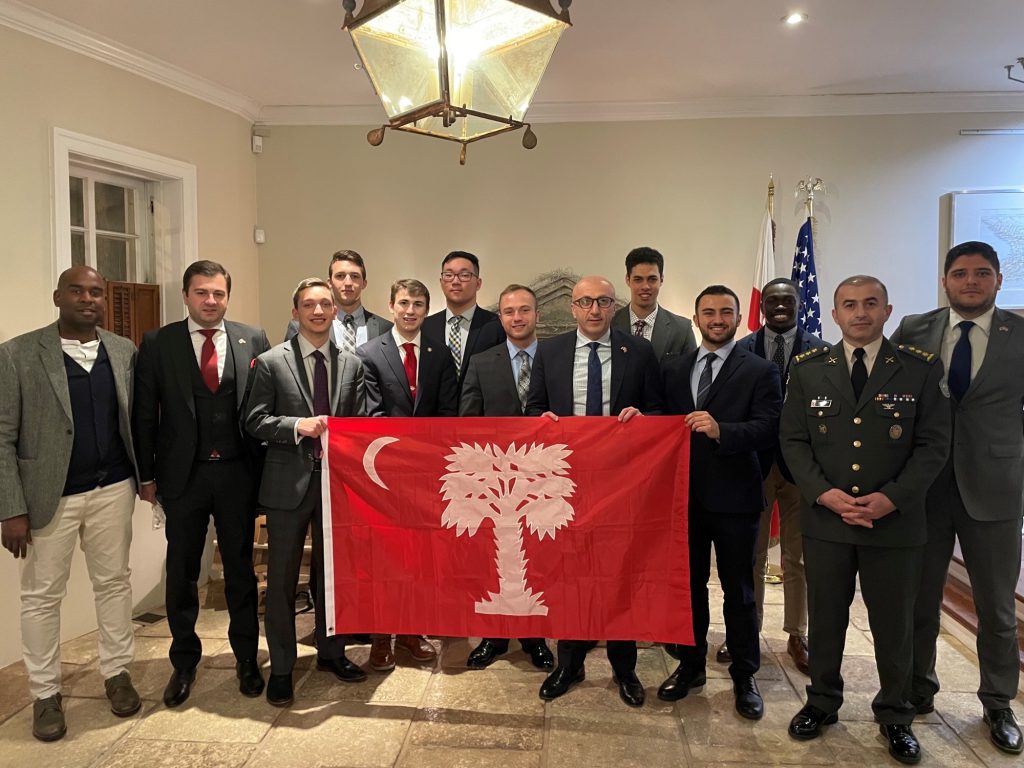 Citadel cadets and students holding The Citadel's flag with Georgian dignitaries at the Embassy of Georgia on March 2, 2022