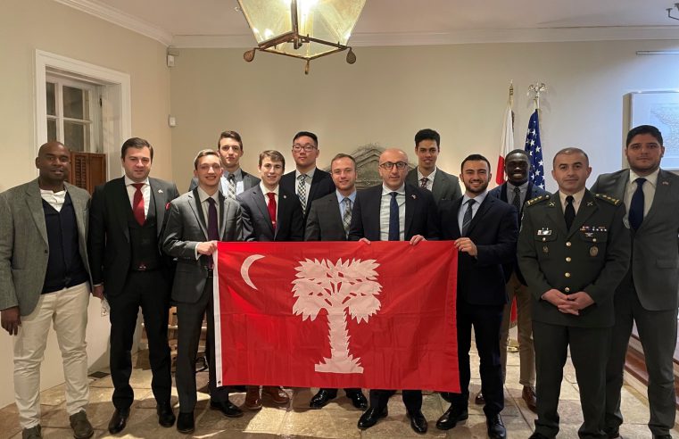Citadel cadets and students holding The Citadel's flag with Georgian dignitaries at the Embassy of Georgia on March 2, 2022