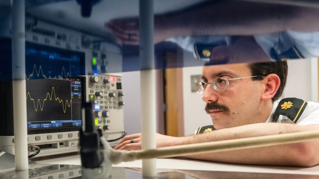 Greg Mazzaro, Associate Professor in the Department of Electrical and Computer Engineering at the Citadel works with his invention, a prototype device designed to detect IED triggers.